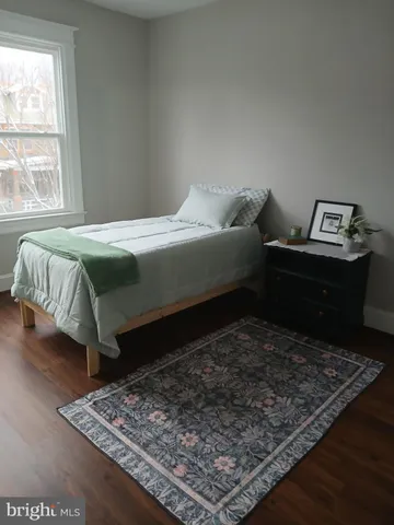 a bed sitting in a bedroom next to a window