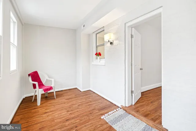 a workspace with a bed and a wooden floor