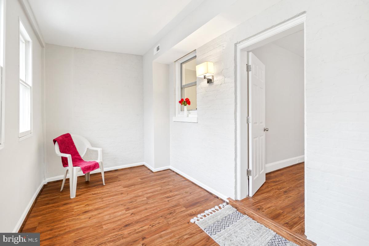 1526 Spring Place Northwest Washington, DC 20010 - Photo 24 of 35 a workspace with a bed and a wooden floor