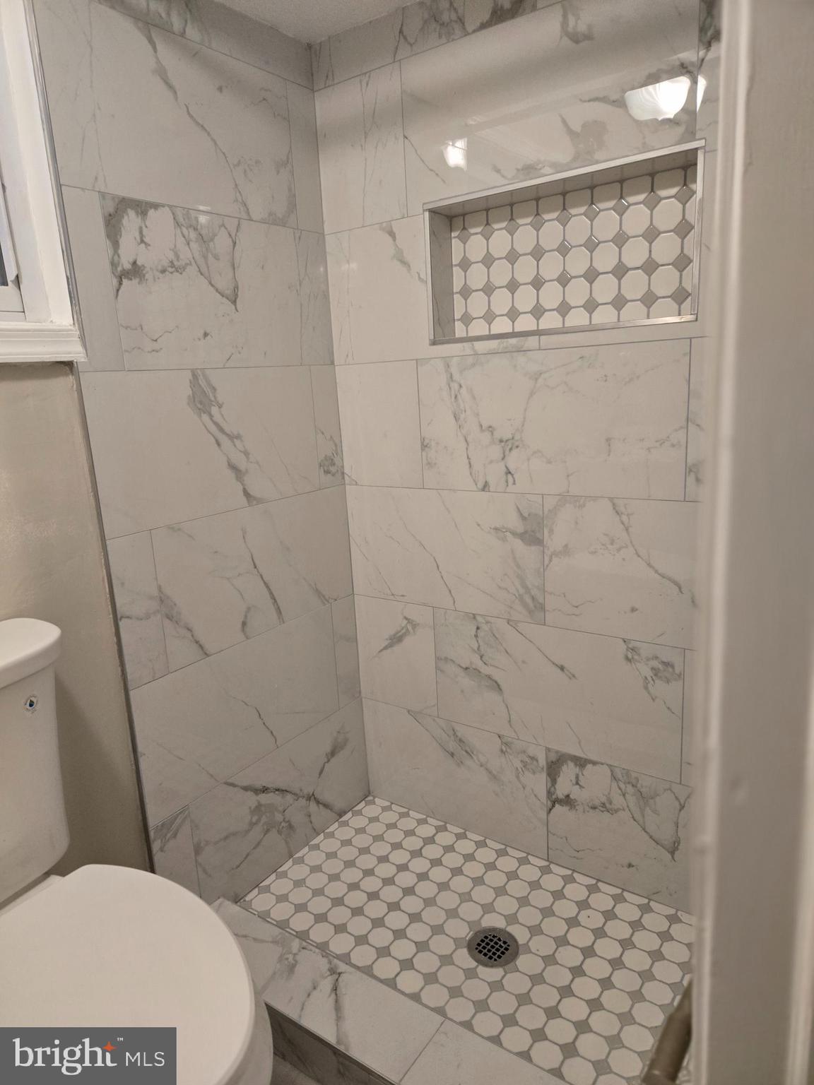 1526 Spring Place Northwest Washington, DC 20010 - Photo 28 of 35 a bathroom with a sink a toilet and shower