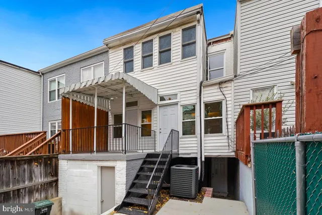 a view of a house with iron stairs