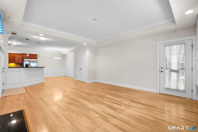 a view of empty room with wooden floor