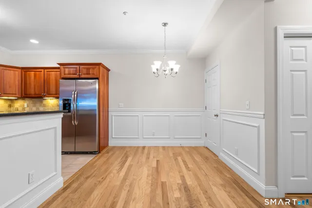a view of a kitchen with a sink and a refrigerator