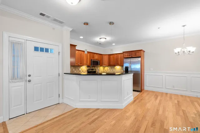 a view of kitchen cabinets and stainless steel appliances