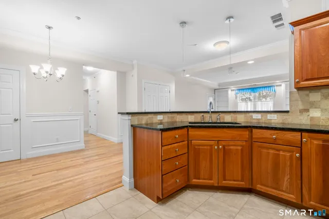a kitchen with stainless steel appliances granite countertop a sink and cabinets
