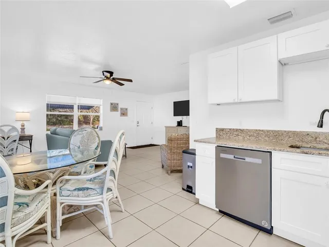 a kitchen with a table chairs and a refrigerator