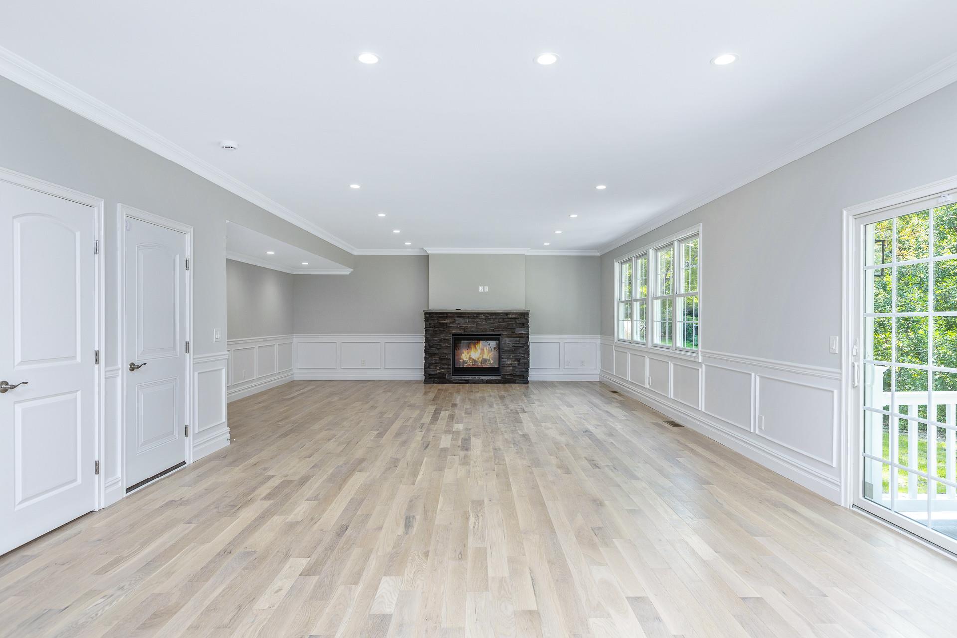 223 Town Line Road Commack, NY 11731 - Photo 11 of 32 a view of an empty room with wooden floor and a window