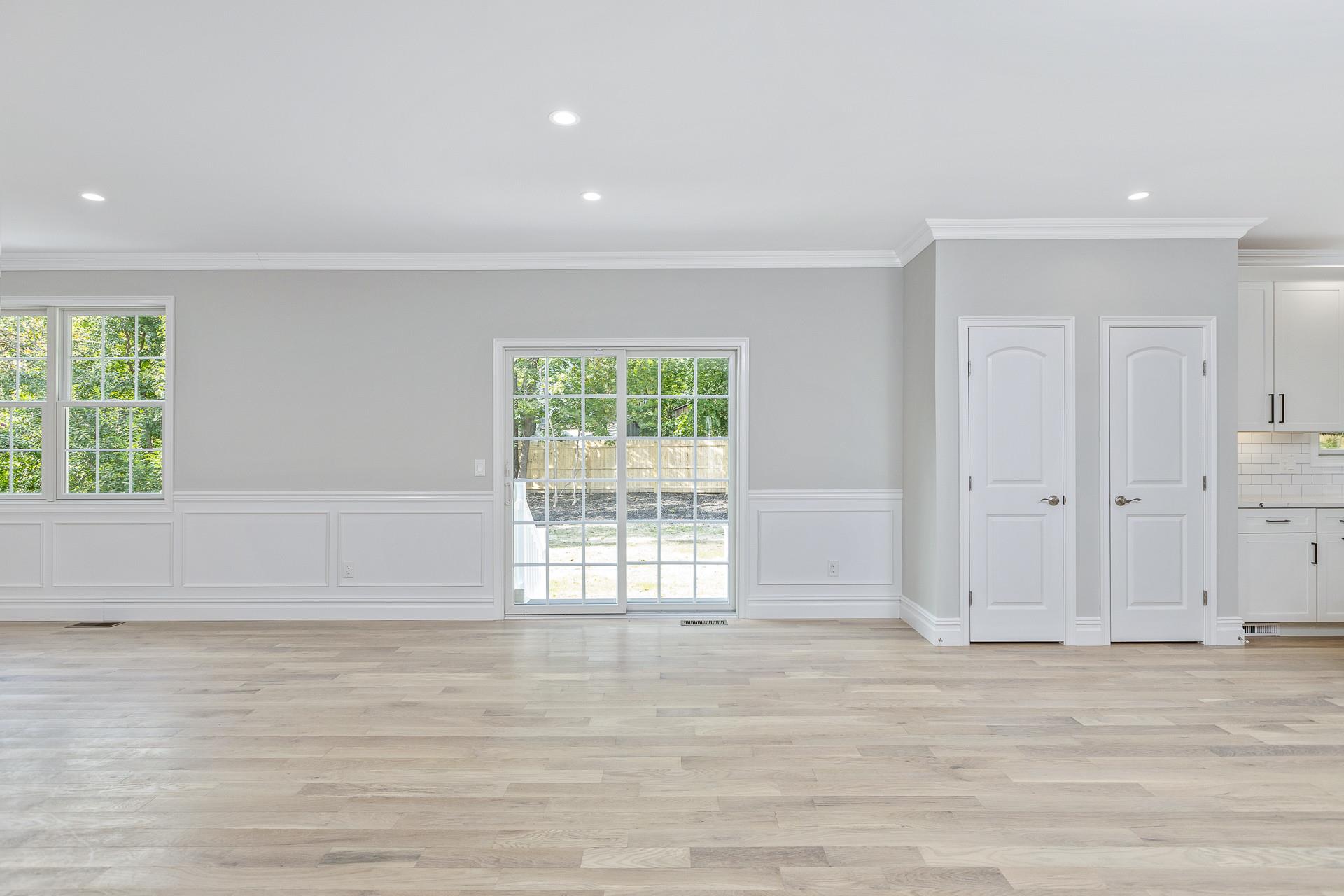 223 Town Line Road Commack, NY 11731 - Photo 13 of 32 a view of an empty room with wooden floor and a window