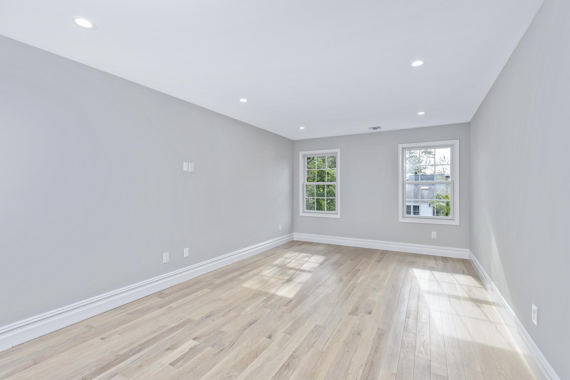 223 Town Line Road Commack, NY 11731 - Photo 15 of 32 an empty room with wooden floor and windows