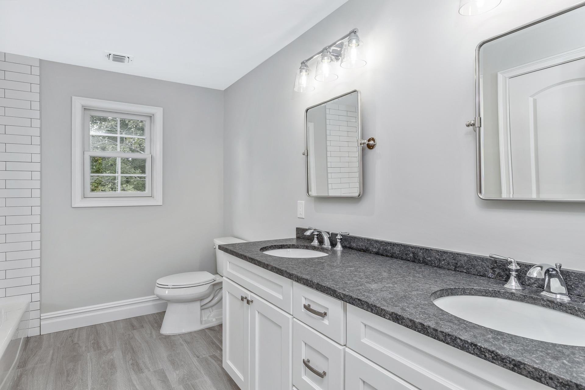 223 Town Line Road Commack, NY 11731 - Photo 17 of 32 a bathroom with a granite countertop sink and a mirror