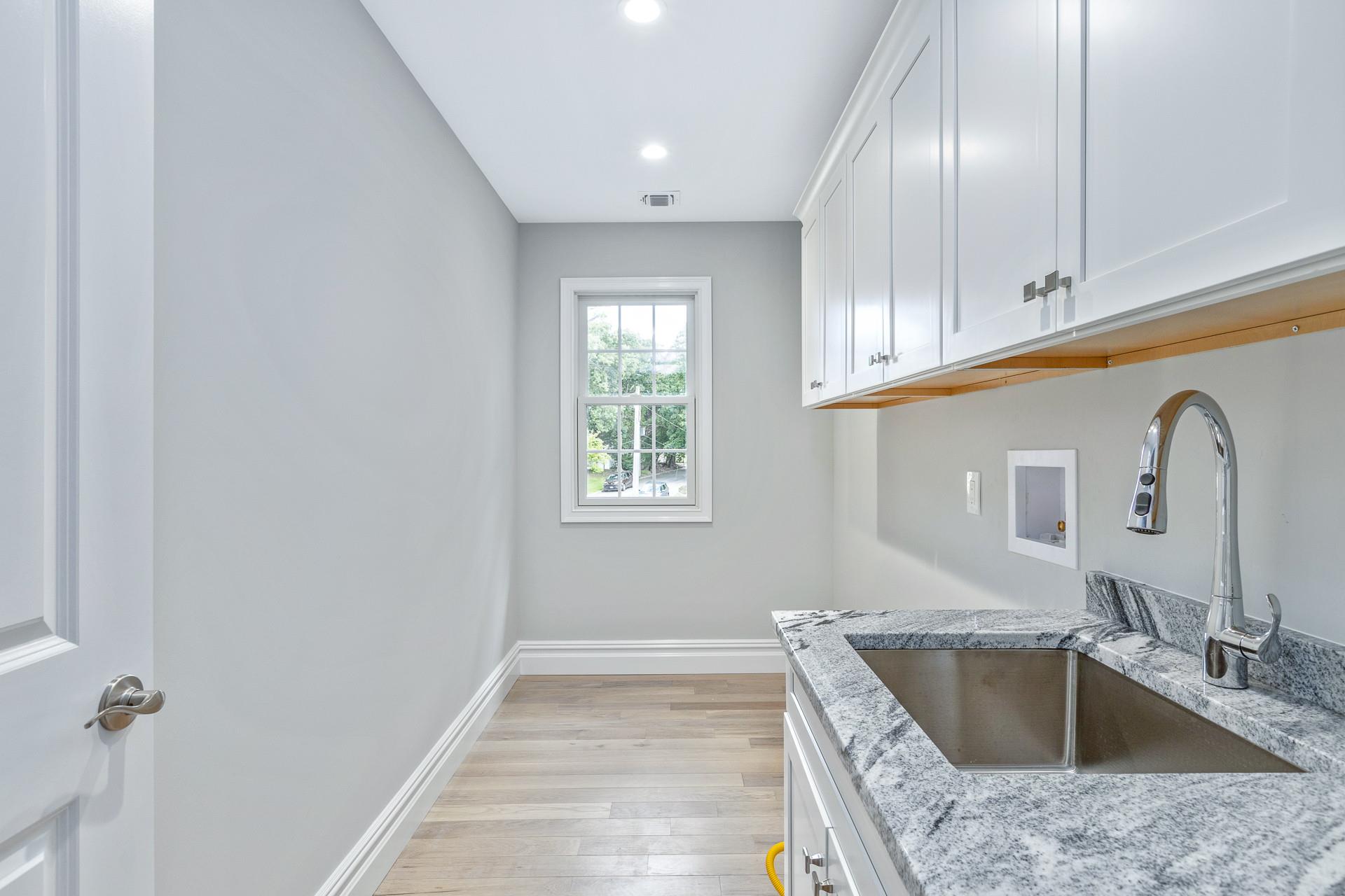 223 Town Line Road Commack, NY 11731 - Photo 18 of 32 a kitchen with a granite countertop sink and natural light