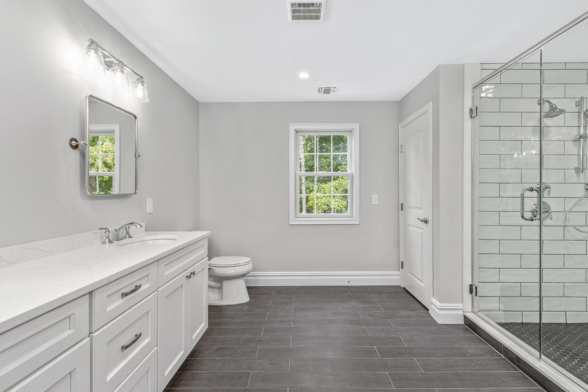 223 Town Line Road Commack, NY 11731 - Photo 20 of 32 a bathroom with a granite countertop sink toilet and painting on the wall