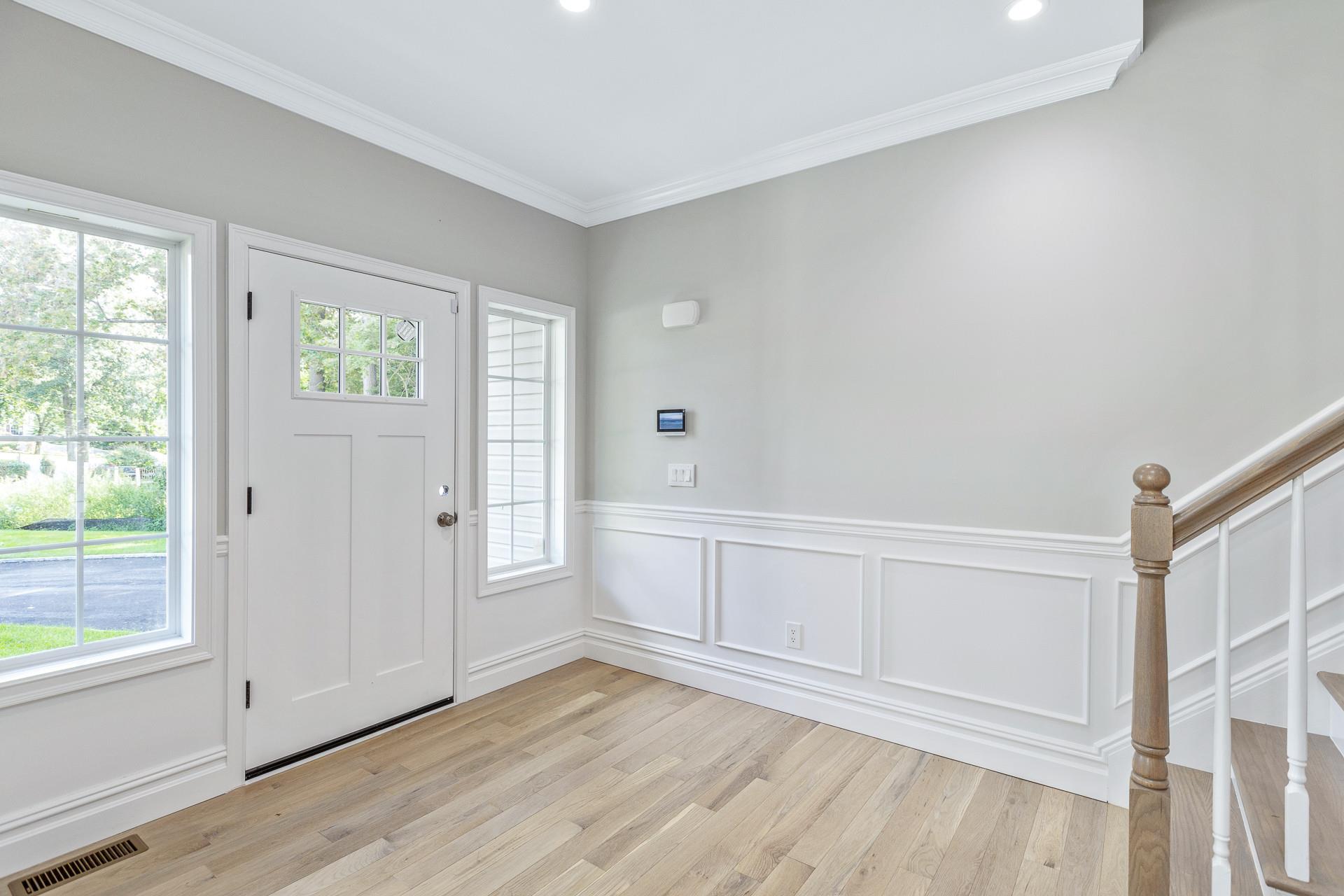 223 Town Line Road Commack, NY 11731 - Photo 2 of 32 a view of an empty room with wooden floor and a window