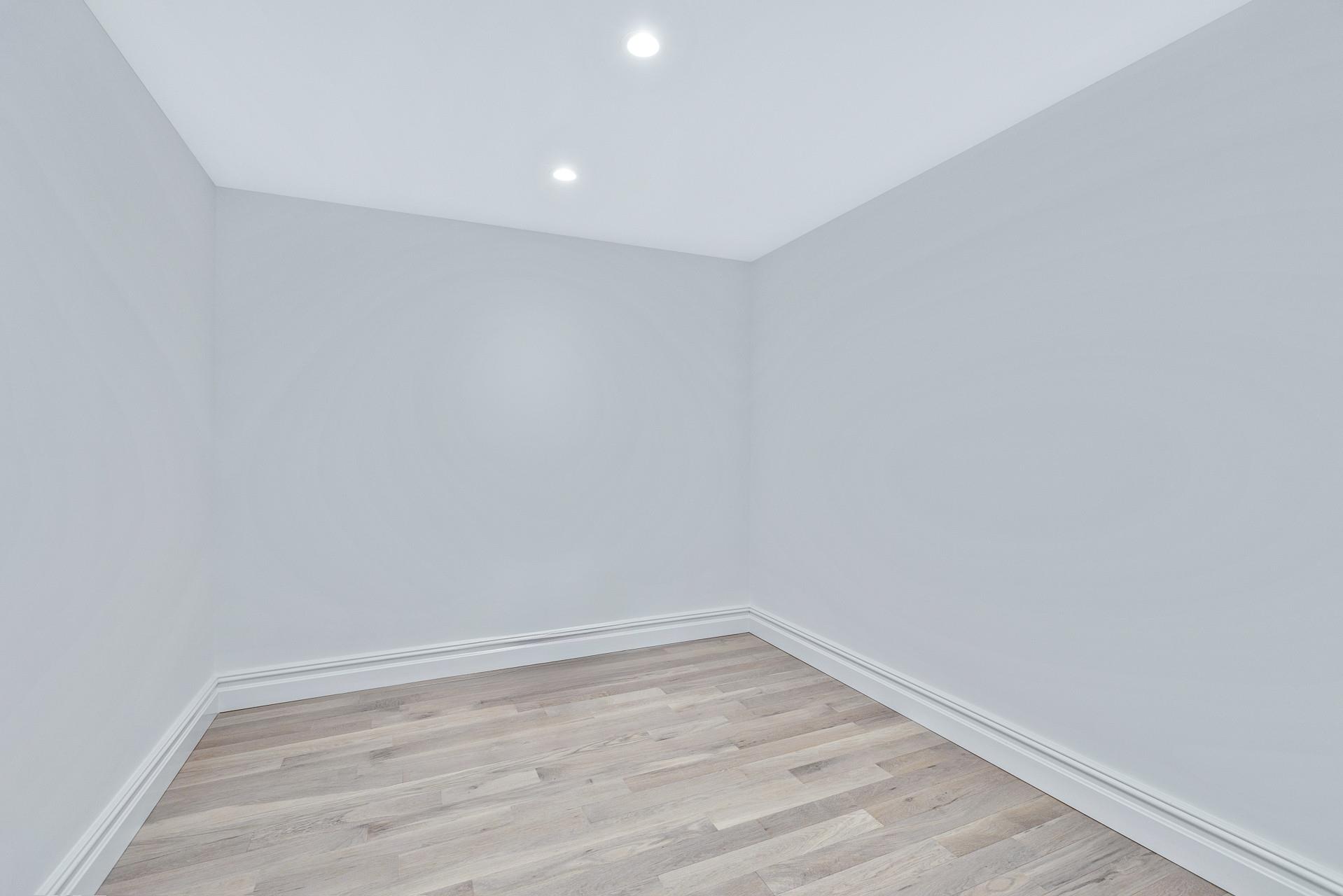 223 Town Line Road Commack, NY 11731 - Photo 23 of 32 a view of an empty room with wooden floor