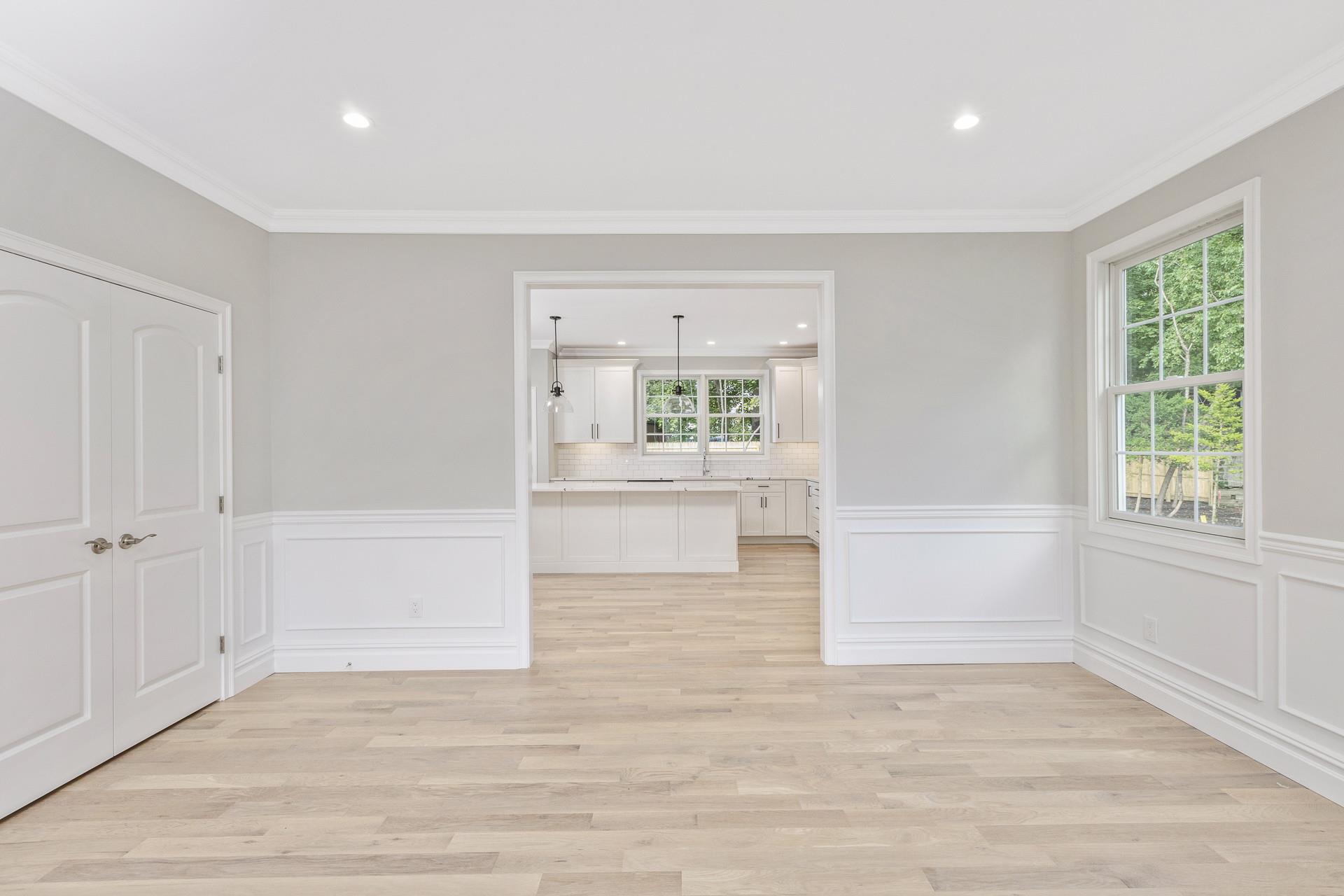 223 Town Line Road Commack, NY 11731 - Photo 5 of 32 wooden floor in an empty room with a window