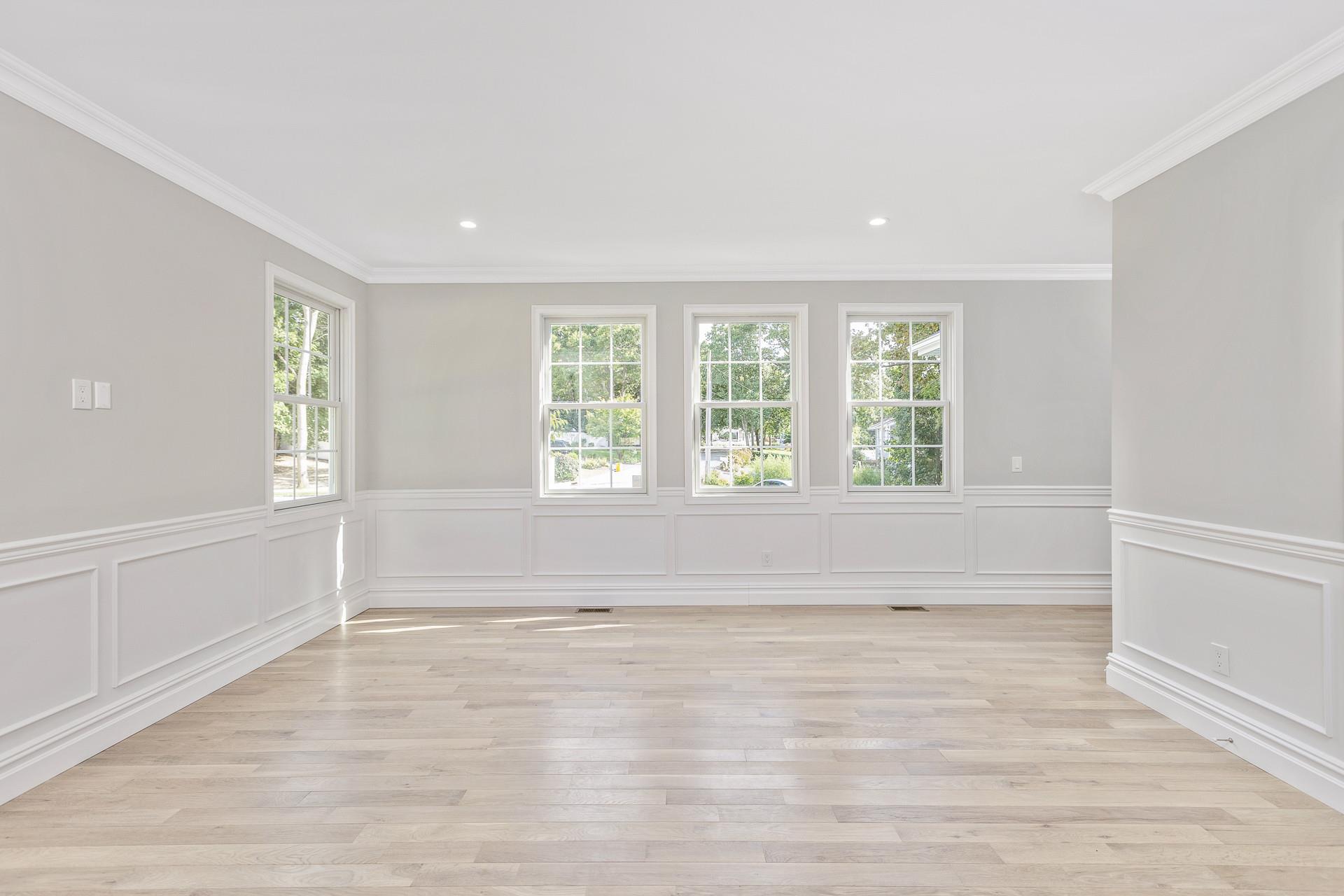 223 Town Line Road Commack, NY 11731 - Photo 6 of 32 an empty room with wooden floor and windows