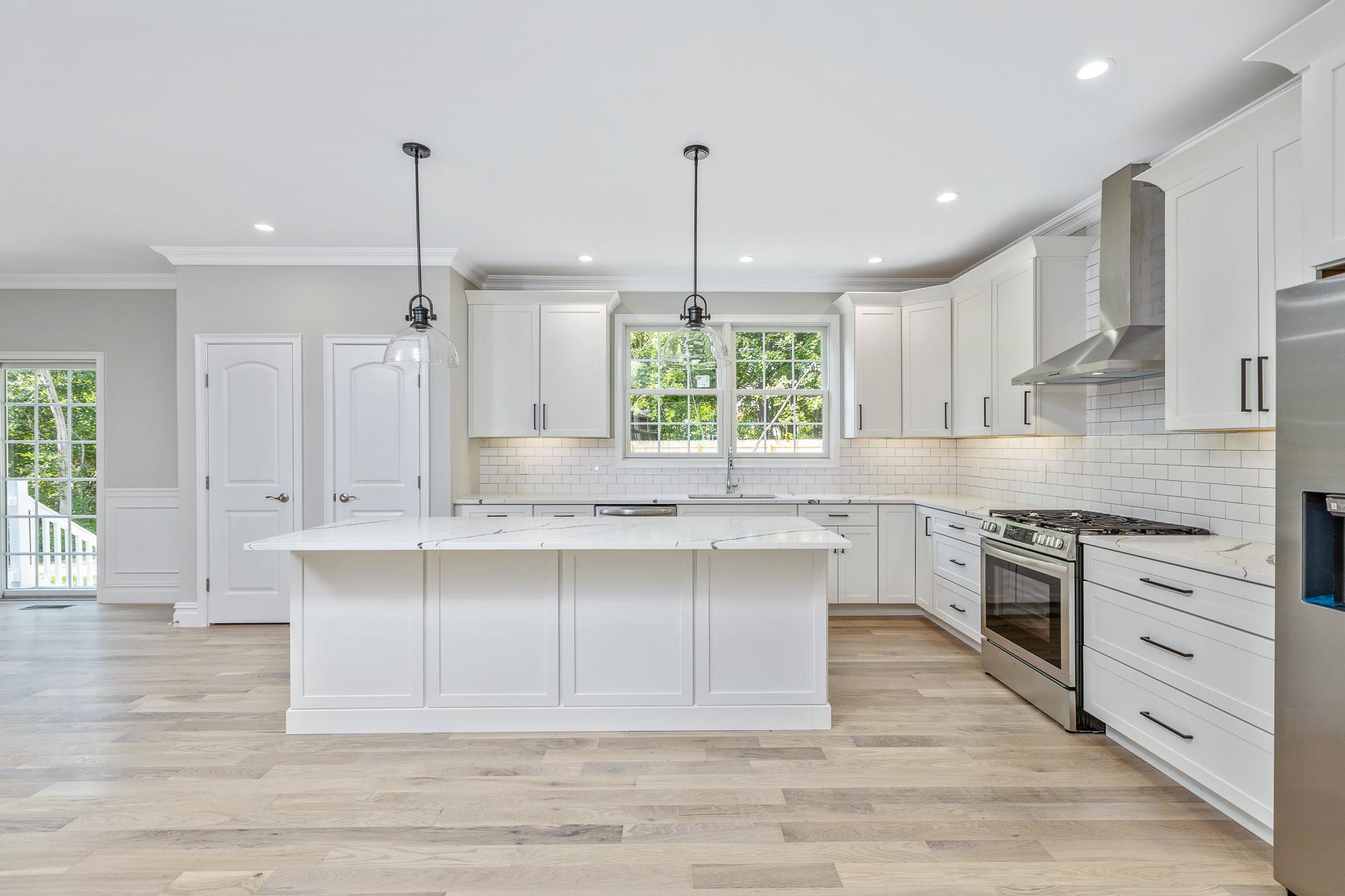 223 Town Line Road Commack, NY 11731 - Photo 7 of 32 a large kitchen with granite countertop a stove top oven a sink a dining table and chairs