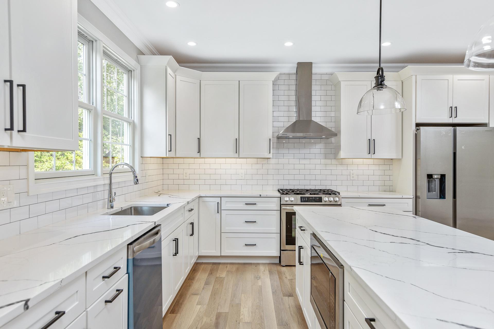 223 Town Line Road Commack, NY 11731 - Photo 8 of 32 a kitchen with a stove a sink a refrigerator and a window