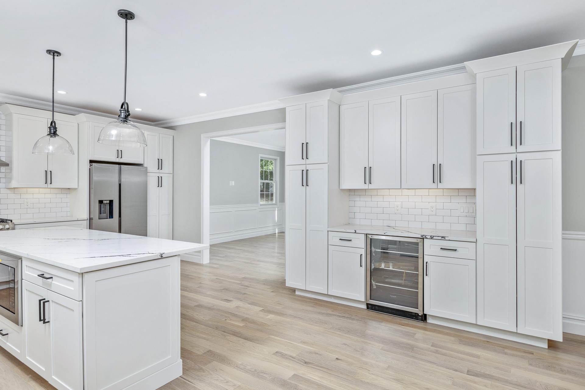 223 Town Line Road Commack, NY 11731 - Photo 10 of 32 a kitchen with white cabinets and stainless steel appliances