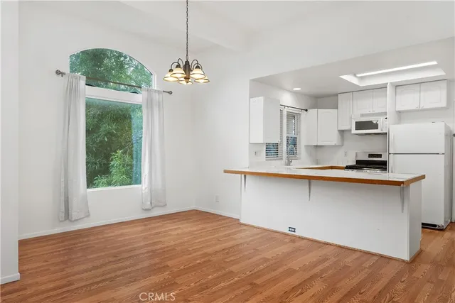 a hallway with window and wooden floor