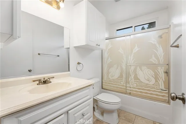 an empty room with window and ceiling fan