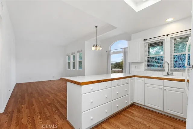 a kitchen with refrigerator cabinets and wooden floor