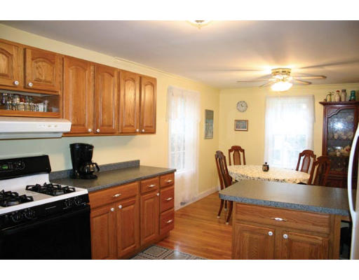 30 Payson Road Brookline, MA 02467 - Photo 3 of 4 a kitchen with granite countertop a stove a sink dishwasher and cabinets with wooden floor