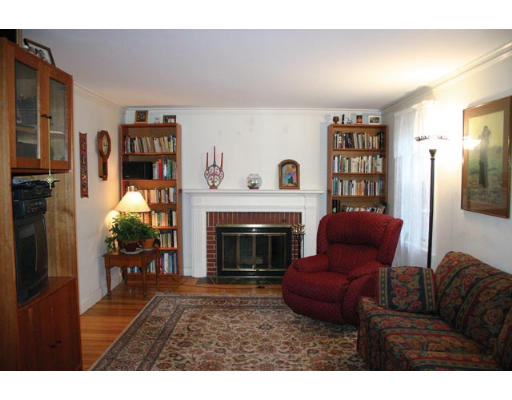 30 Payson Road Brookline, MA 02467 - Photo 4 of 4 a living room with furniture a fireplace and a large window