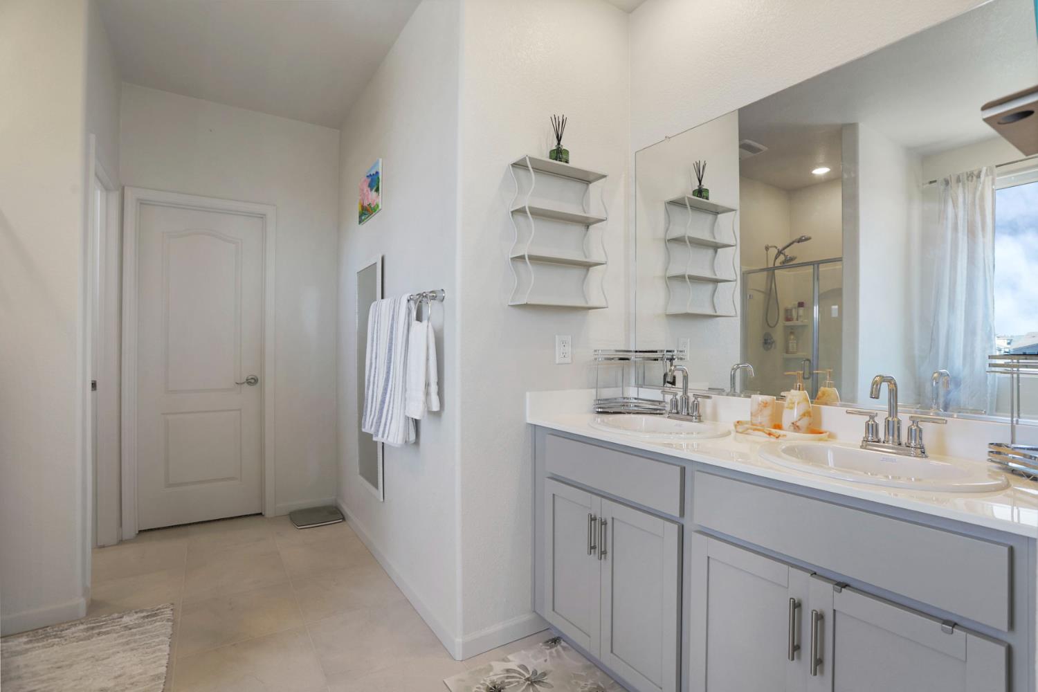 6949 Foraker Drive Stockton, CA 95219 - Photo 27 of 34 a bathroom with a double vanity sink mirror and double