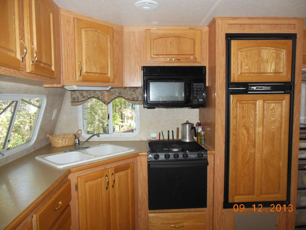 1645 Hayward Flat Road Trinity Center, CA 96091 - Photo 5 of 27 a kitchen with stainless steel appliances granite countertop a stove a sink and a microwave