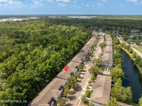 an aerial view of house with yard and mountain view in back
