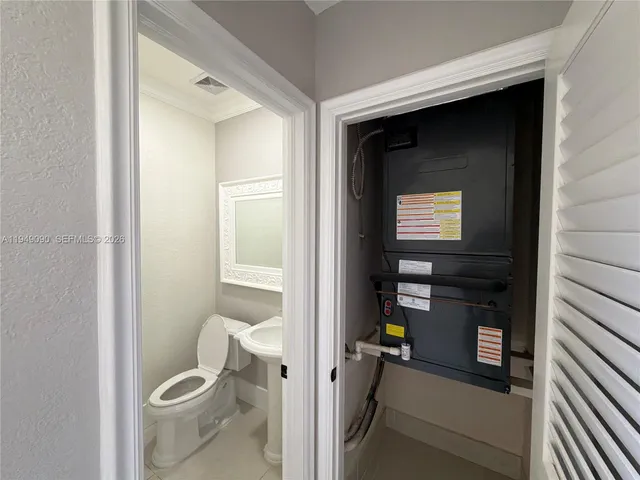 a view of a hallway view with staircase and kitchen view