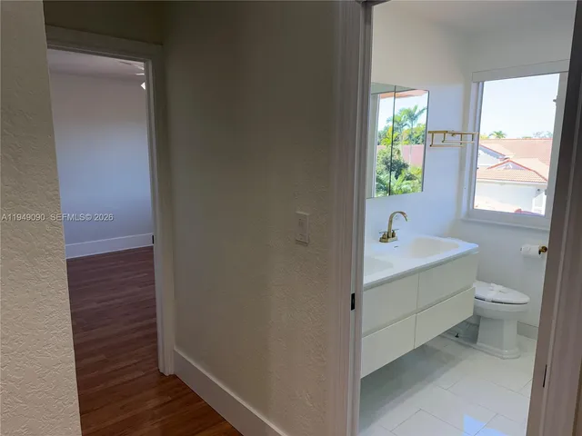 wooden floor in an empty room with a mirror