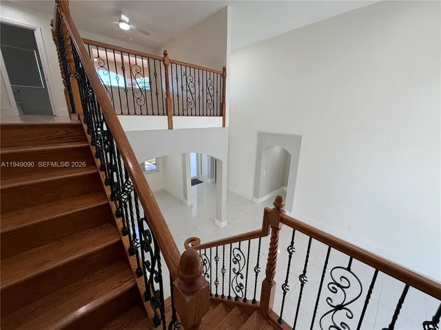 a kitchen with a table chairs refrigerator and microwave