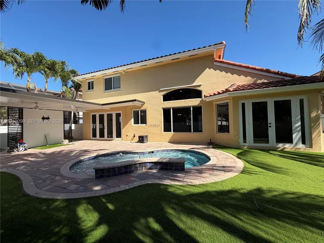 a view of a kitchen with a sink and a refrigerator