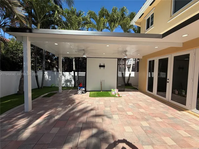 a large kitchen with stainless steel appliances a stove a sink and a refrigerator