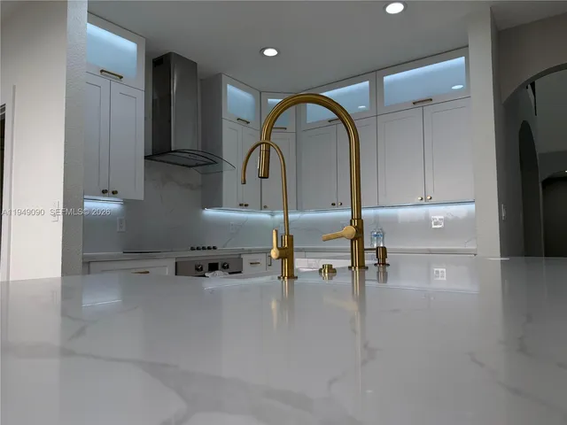 a kitchen with stainless steel appliances granite countertop a sink and cabinets
