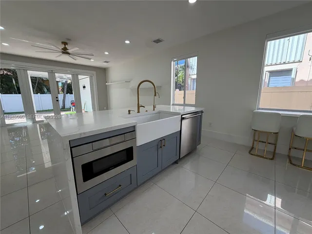 a kitchen with a sink and stainless steel appliances