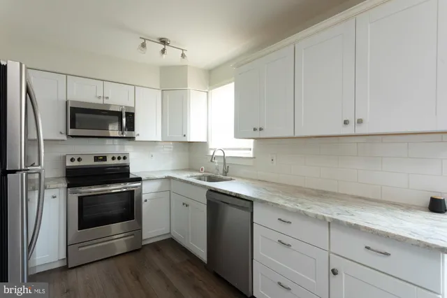 a kitchen with a sink stove and microwave