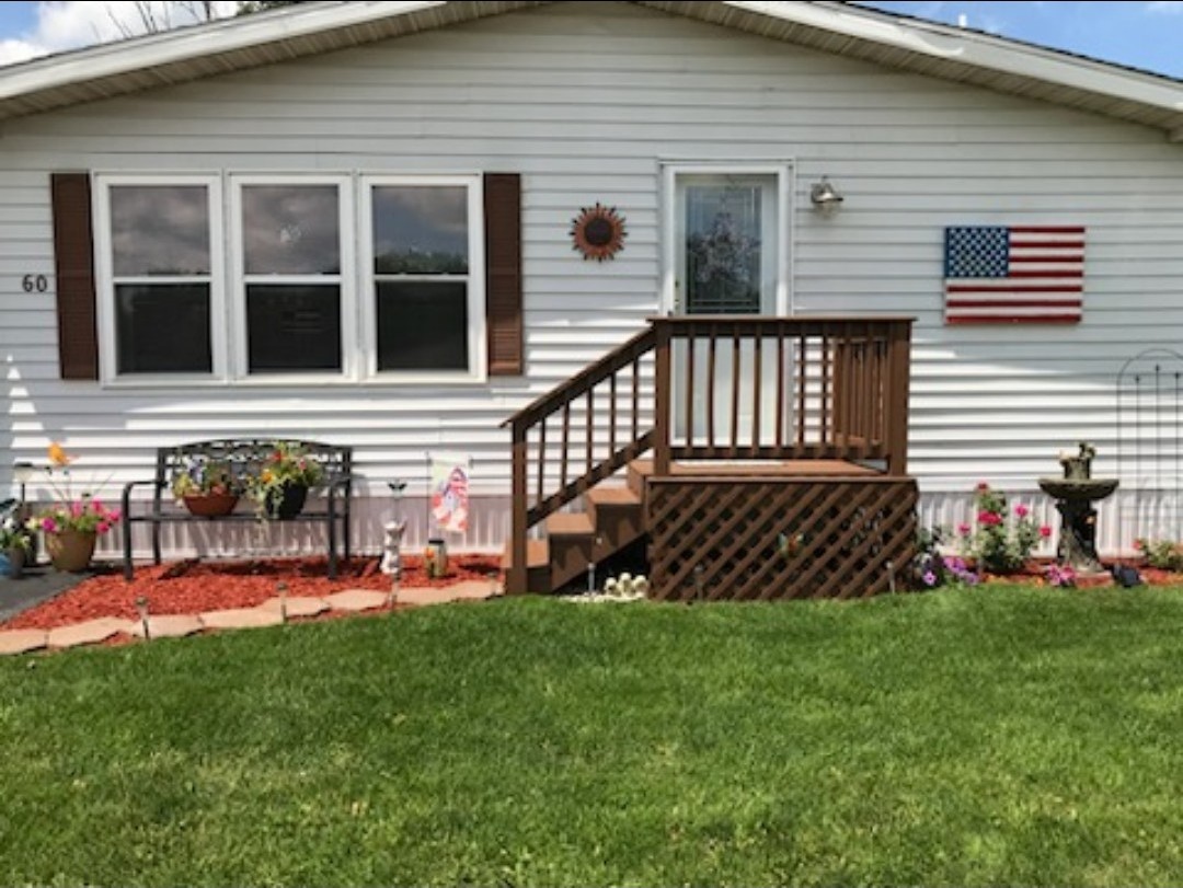 a view of a house with a yard and a deck