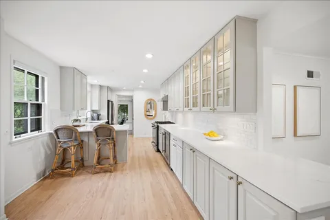 a view of a kitchen with furniture and wooden floor