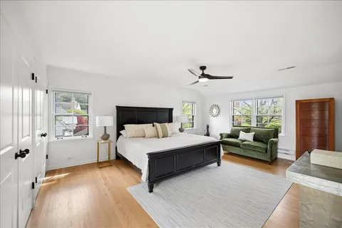 a spacious bedroom with a bed and a large window