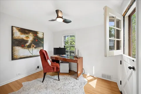 a workspace room with furniture and windows