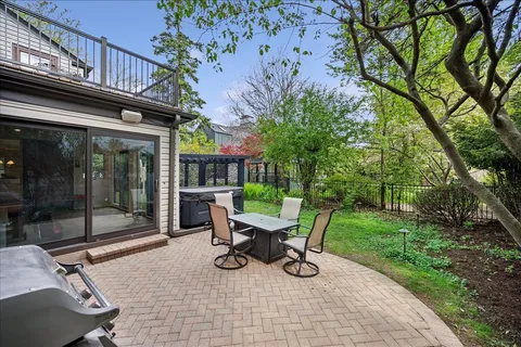a view of a chair and table in backyard of the house