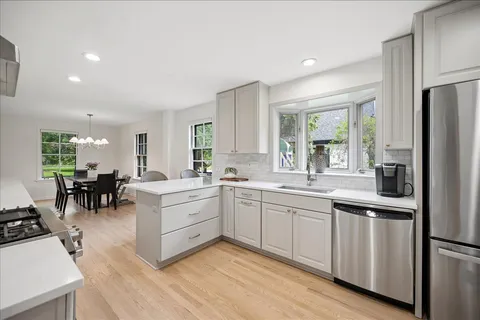 a kitchen with white cabinets and stainless steel appliances