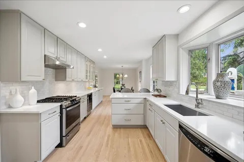 a large kitchen with a stove top oven