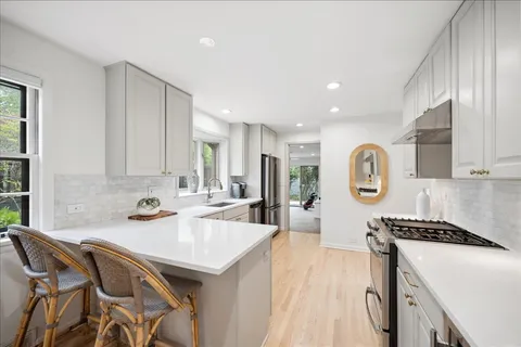 a kitchen with a sink a stove and cabinets