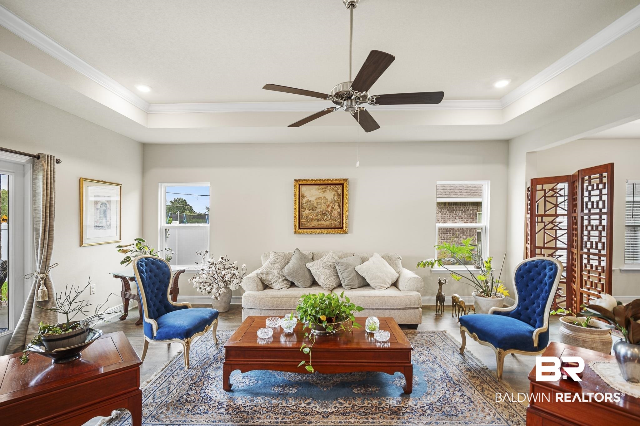 24765 Spectacular Bid Loop Daphne, AL 36526 - Photo 16 of 45 Living room with crown molding, hardwood / wood-style flooring, a raised ceiling, and ceiling fan