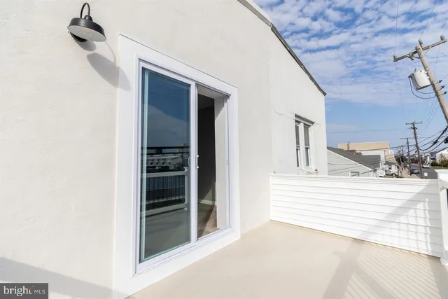 a view of a hallway with a white walls and stairs