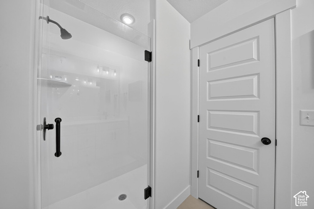 4751 Heartwood Road Mapleton, UT 84664 - Photo 19 of 33 Walk-in shower with clear glass enclosure and matte black hardware, featuring a recessed ceiling light